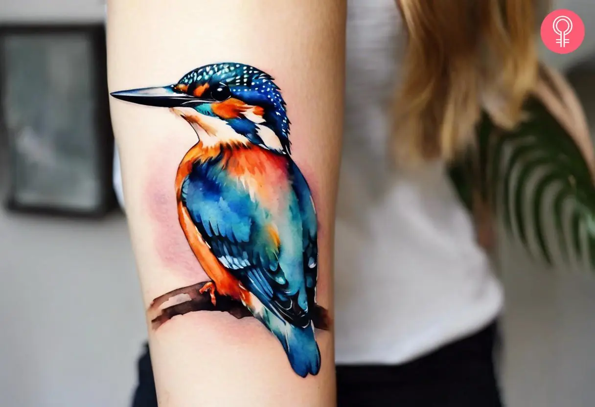 A colorful kingfisher tattoo on the upper arm