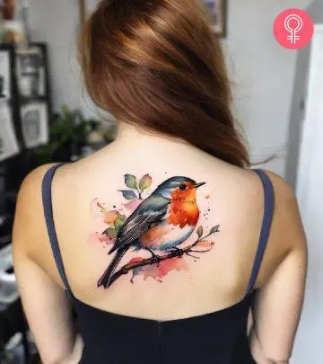 Bird Of Paradise tattoo on the upper arm of a woman