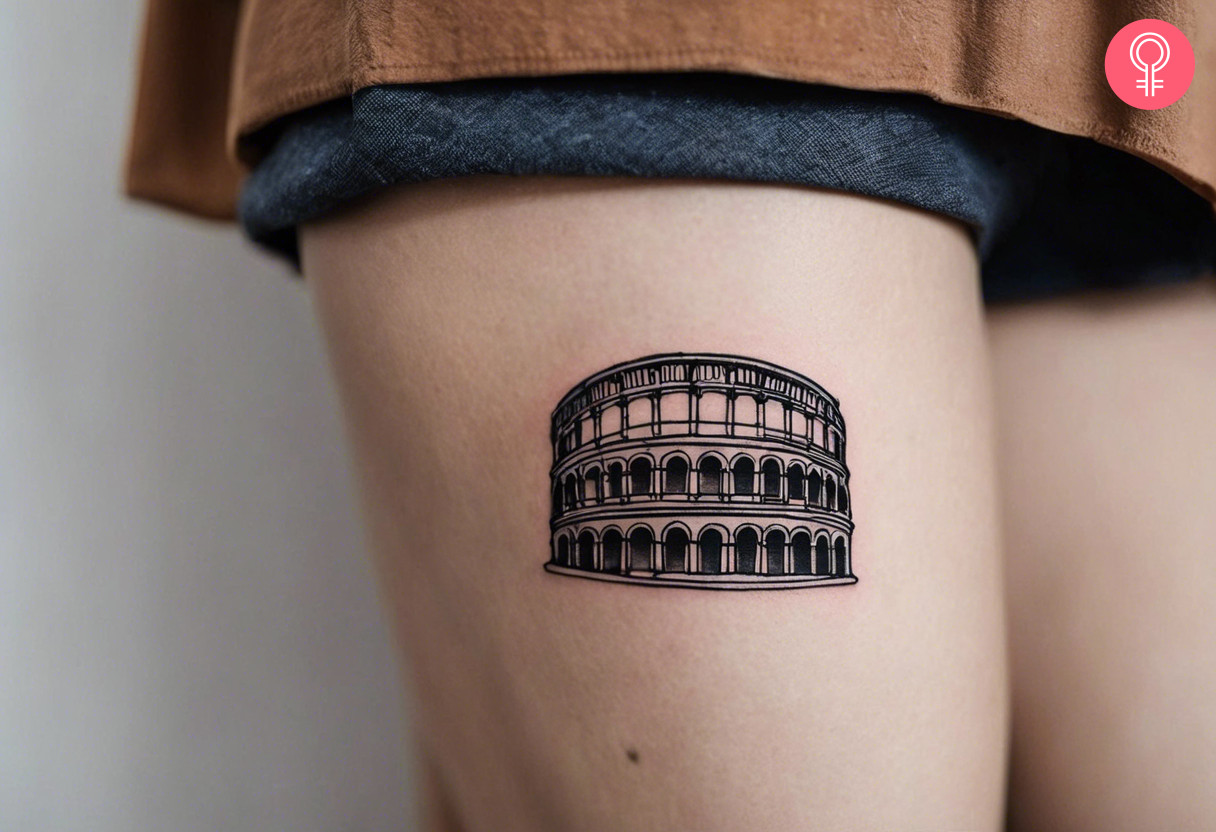 A colosseum tattoo on the thigh of a woman