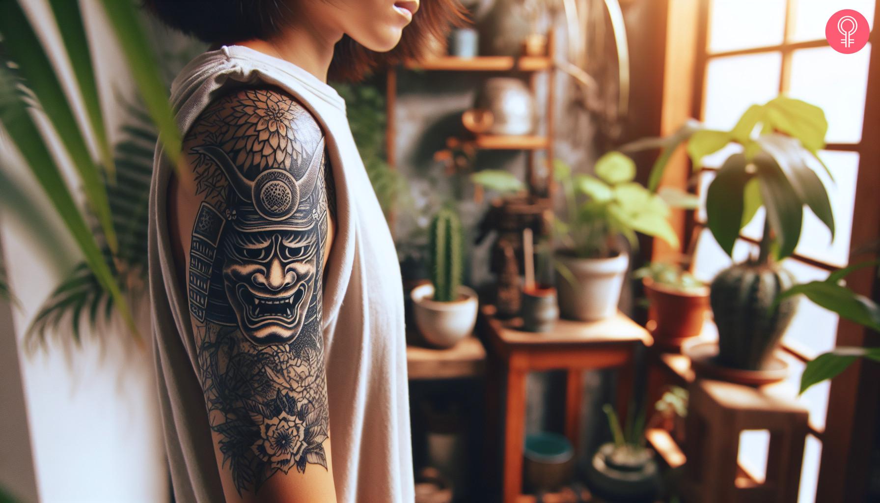 A Japanese samurai death mask tattoo on a woman's upper arm