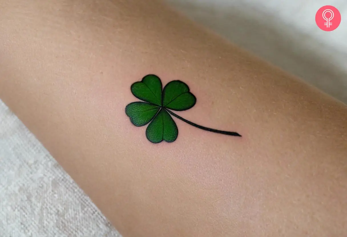 A four-leaf clover tattoo on the forearm