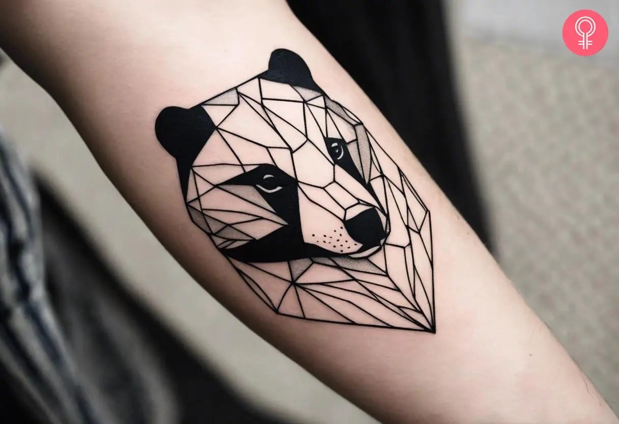 A geometric badger tattoo on the forearm