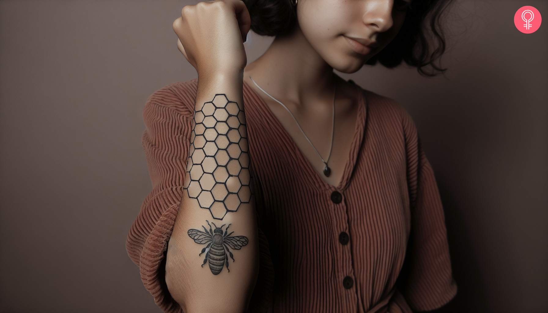 A geometric beehive tattoo on the forearm of a woman