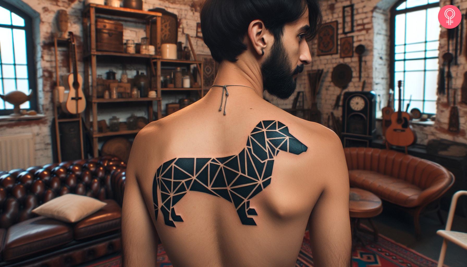 A geometric dachshund tattoo on the back of a man