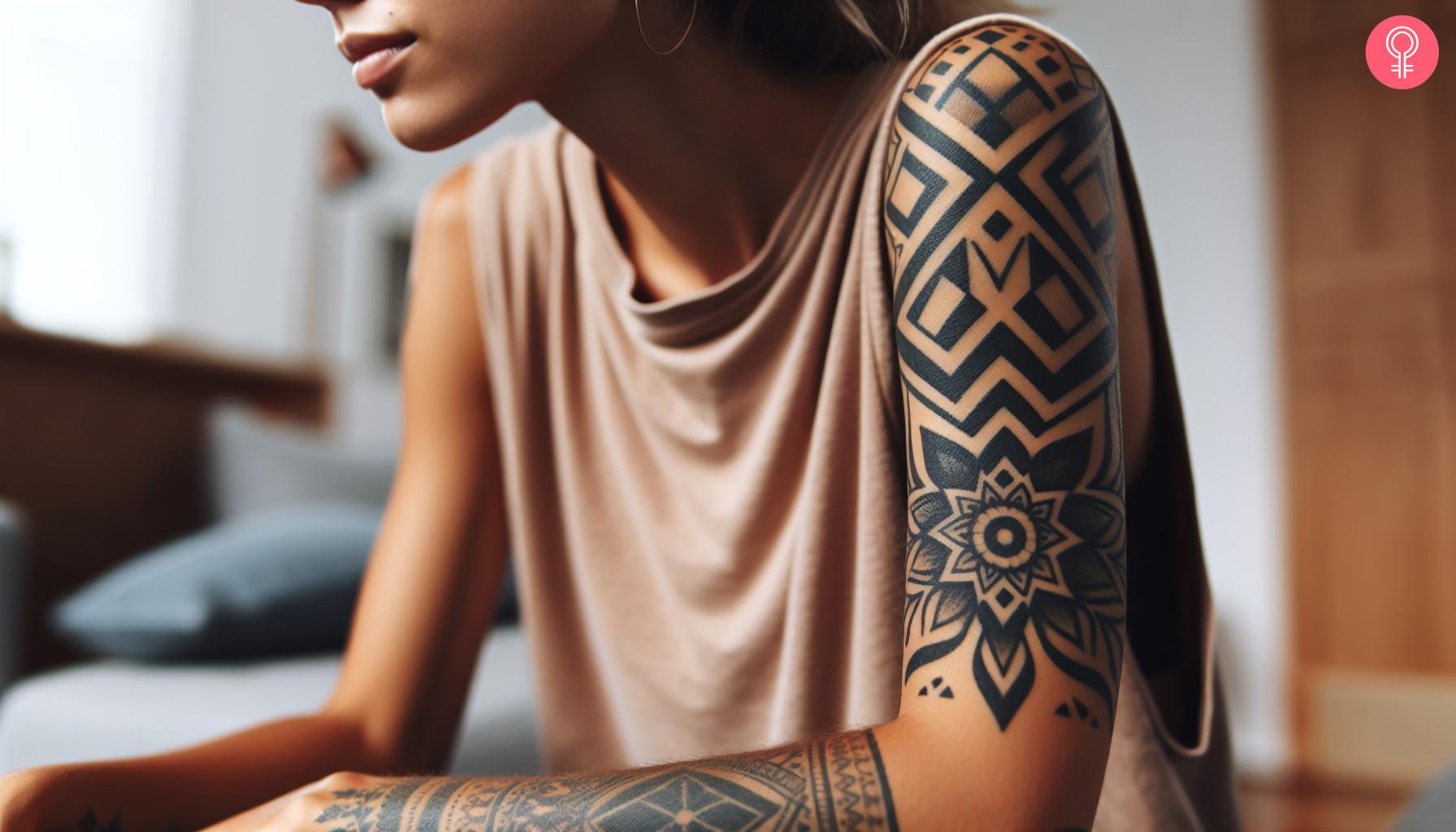 A geometric gap filler tattoo on a woman's upper arm