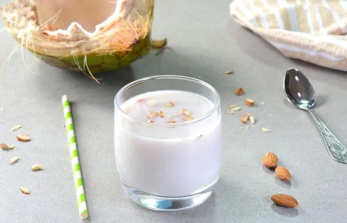 A glass of homemade almond and coconut protein shake on the table