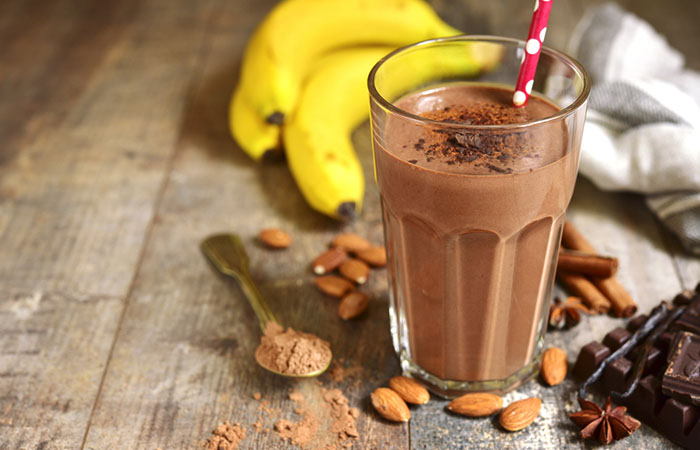 A glass of homemade chocolate protein shake on the table