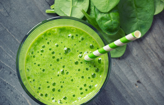 A glass of homemade green power protein shake on the table