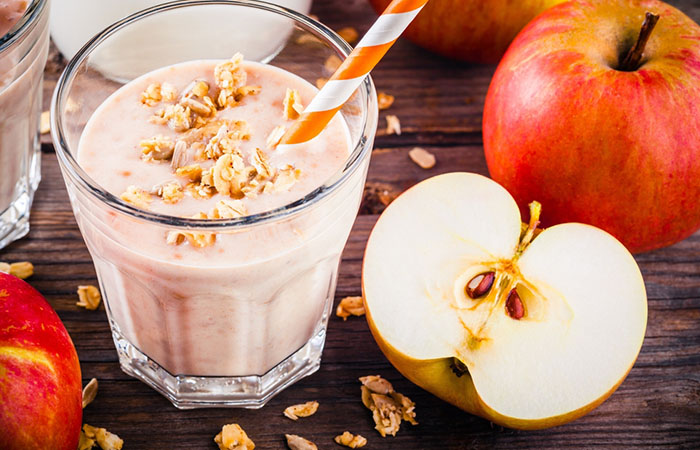 A glass of homemade oatmeal and apple protein shake on the table