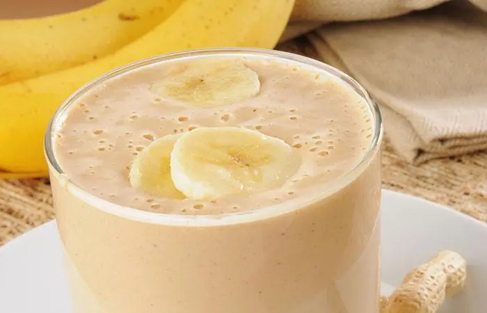 A glass of homemade peanut butter and banana protein shake on the table