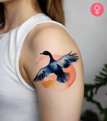 A woman with a minimalist tattoo of a Phoenix in black ink.