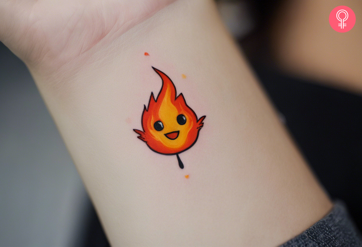 A happy Calcifer tattoo on the back of the wrist