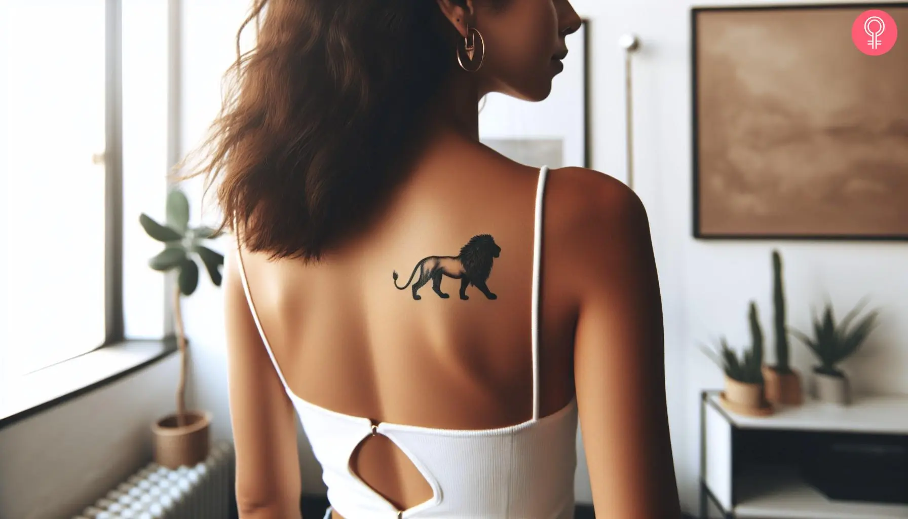 A lion walking tattoo on the shoulder blade of a woman