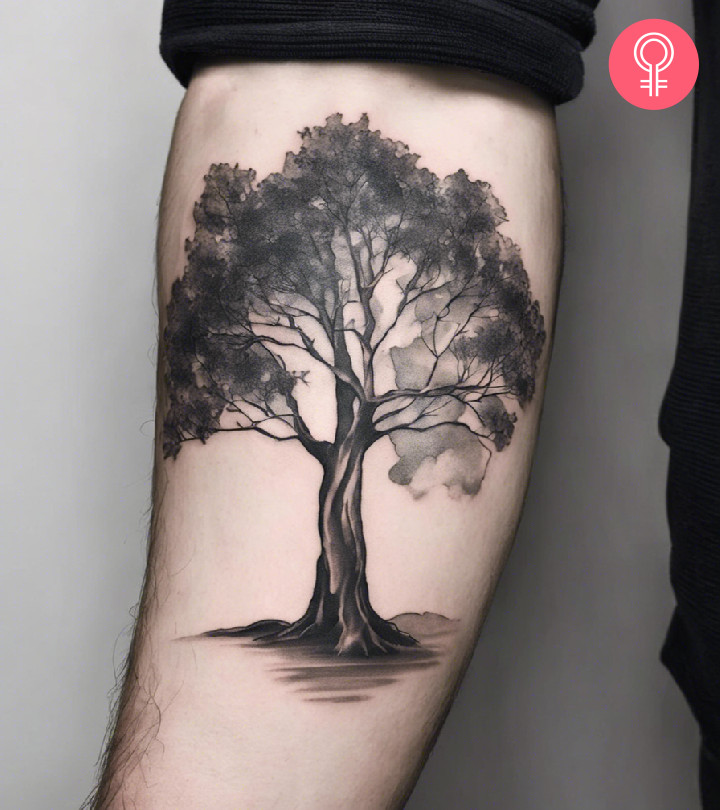 A man wearing a eucalyptus tree tattoo on his lower arm