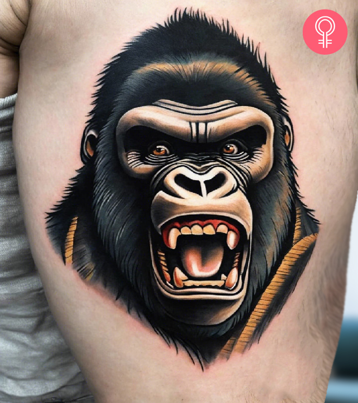 A man wearing a traditional King Kong tattoo on the upper arm.