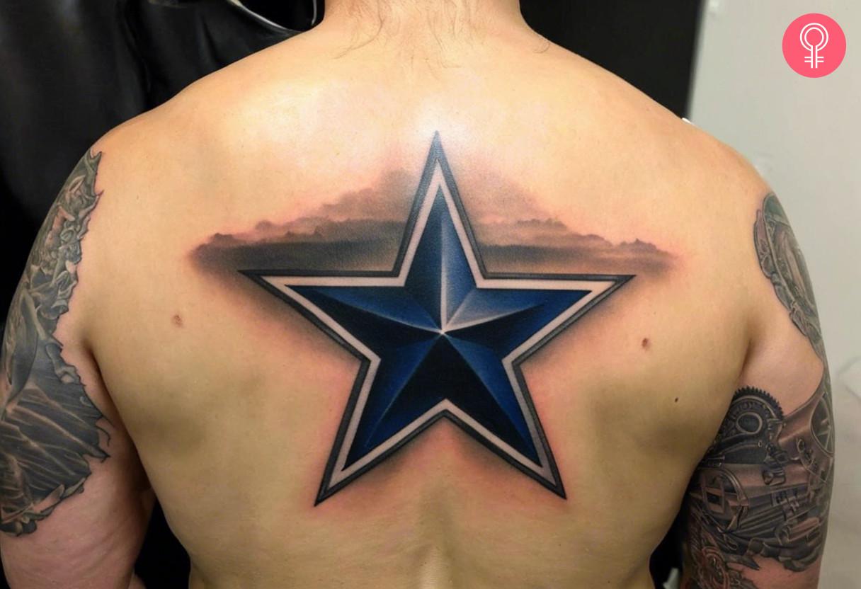 A man with a Dallas Cowboys gangster tattoo on his back.