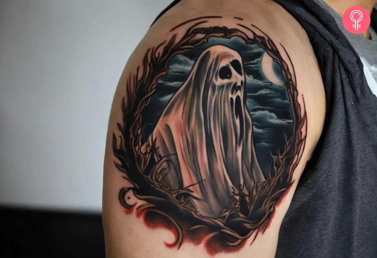 A man with a traditional horror tattoo on his upper arm