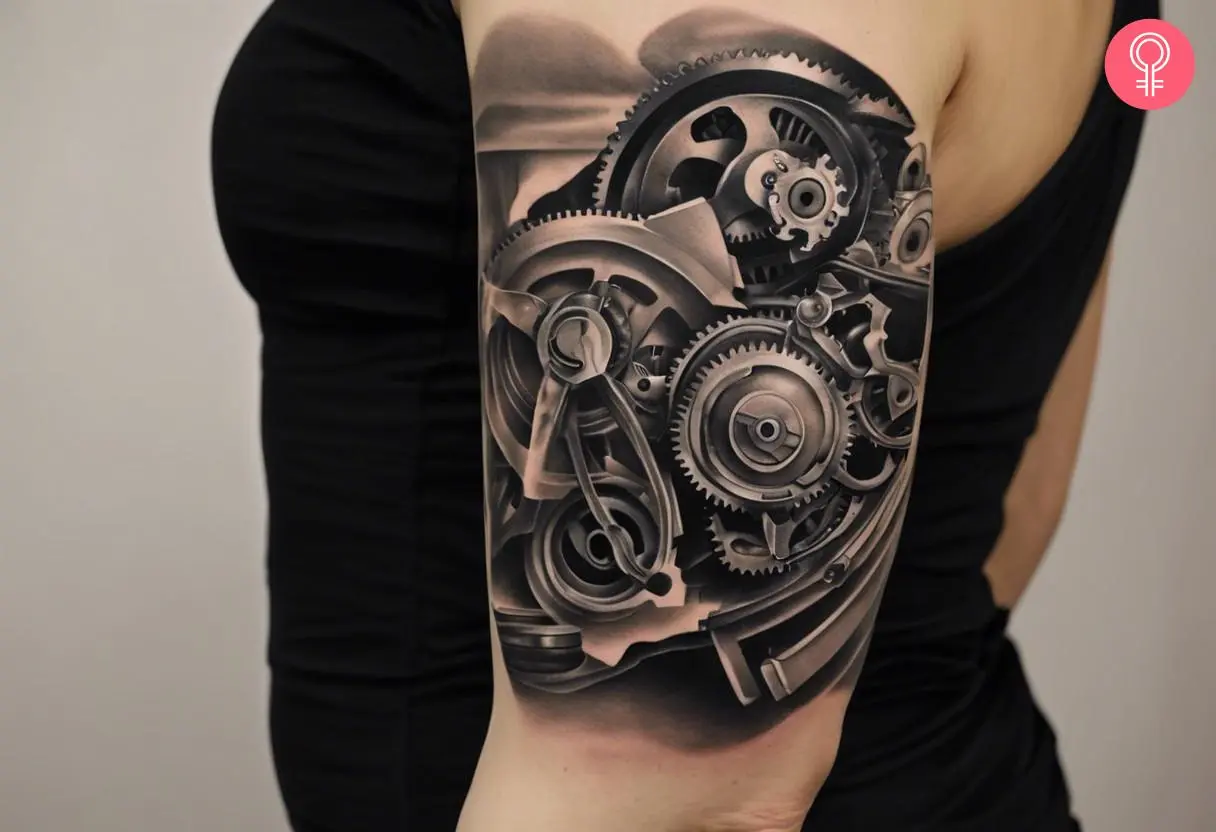 A mechanical engine tattoo on a woman’s upper arm