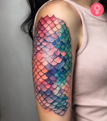 A pretty watercolor fish tattoo on the upper arm