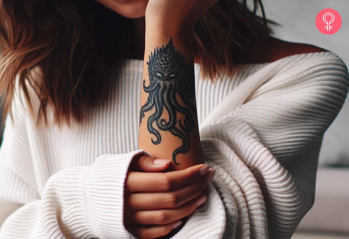 A minimalist and simple Cthulhu tattoo on a woman's wrist