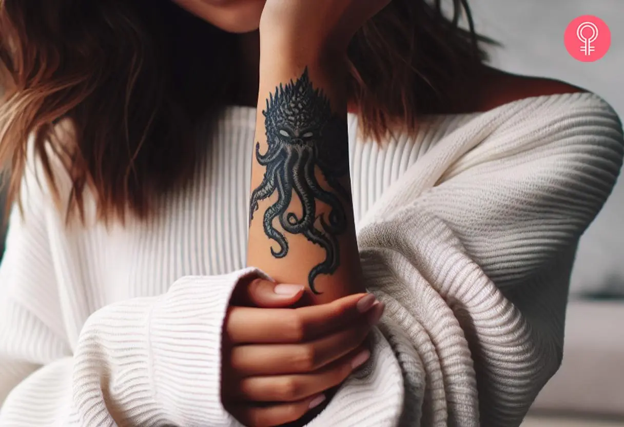 A minimalist and simple Cthulhu tattoo on a woman’s wrist