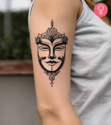 A mask tattoo on the arm