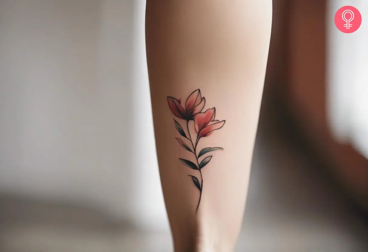 A minimalist flower calf tattoo