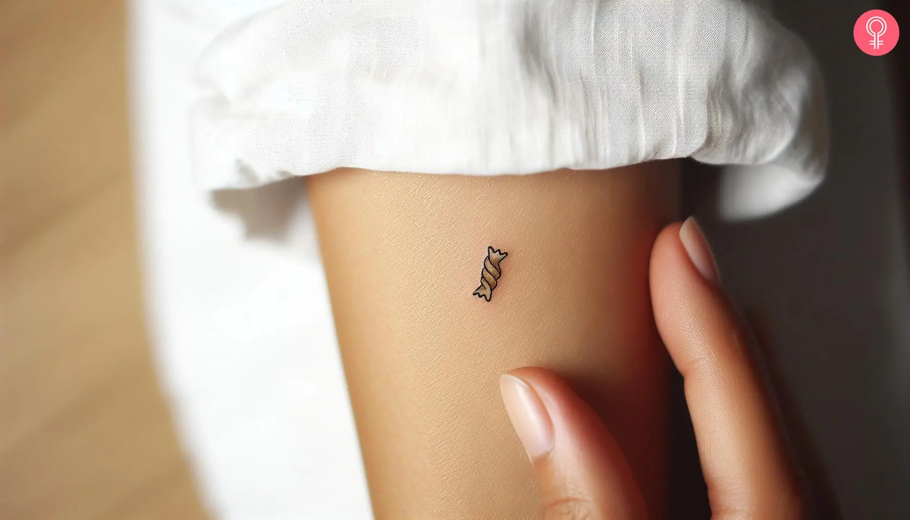 A minimalist pasta tattoo on a woman’s arm