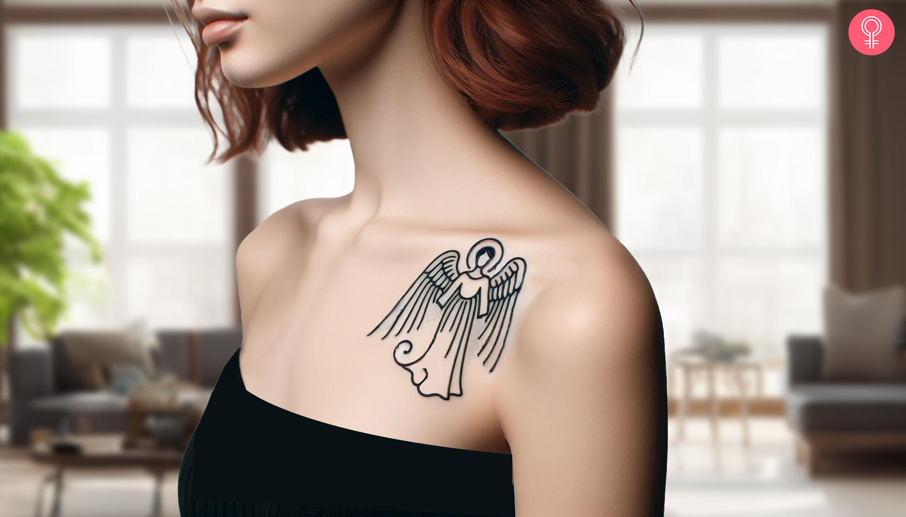 A minimalist tattoo of St. Michael's tattoo etched on the shoulder