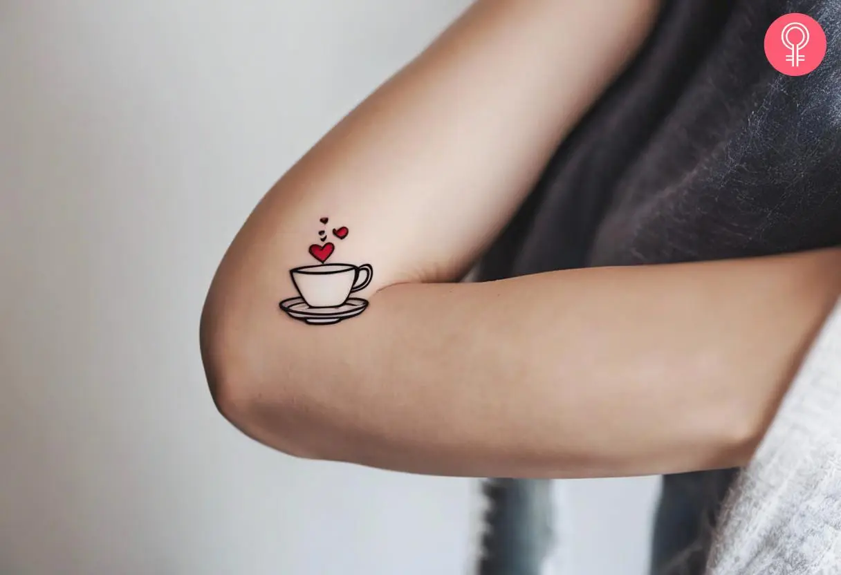 A teacup tattoo on a woman’s upper arm