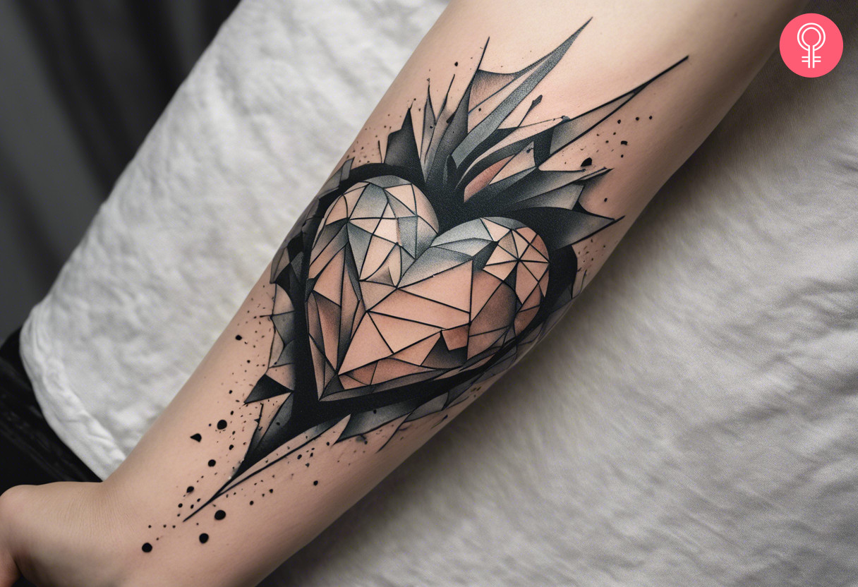 A mosaic broken heart tattoo on the forearm