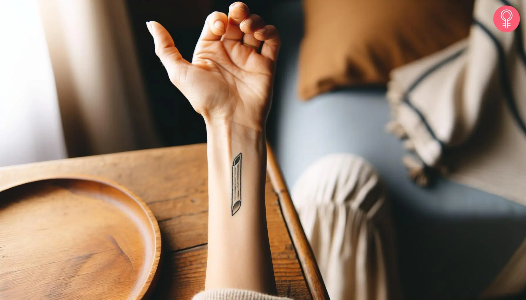 A penne pasta tattoo on a woman’s forearm