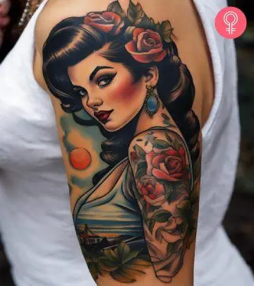 Woman with a haunted house tattoo on the upper arm