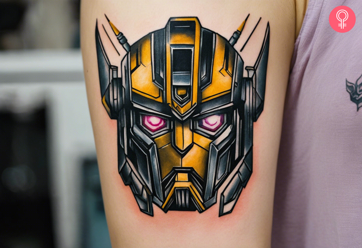 A portrait of a bumblebee transformers with pink eyes tattoo on the upper arm