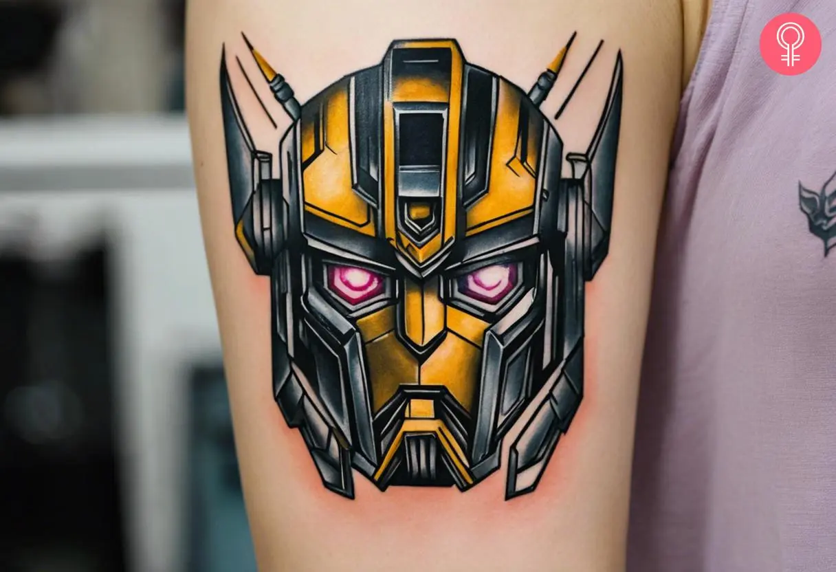 A portrait of a bumblebee transformers with pink eyes tattoo on the upper arm