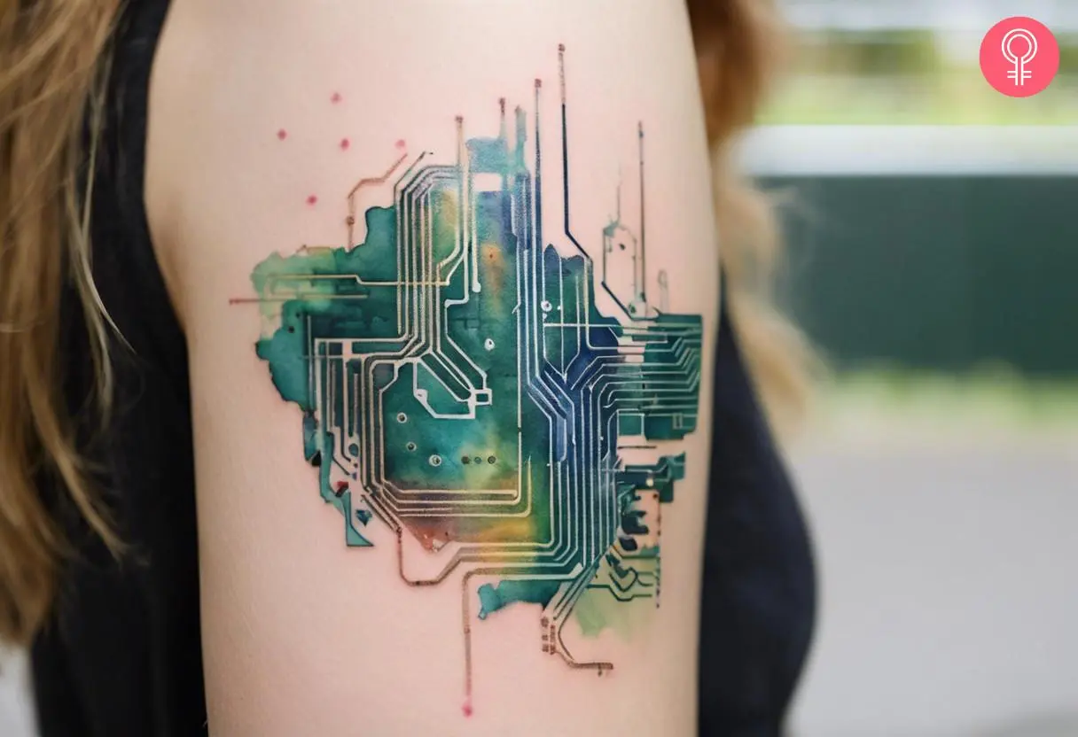 A printed circuit board tattoo on the upper arm of a woman