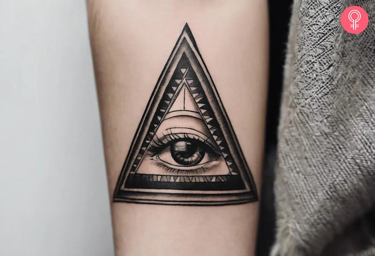 A realistic Illuminati tattoo on the forearm