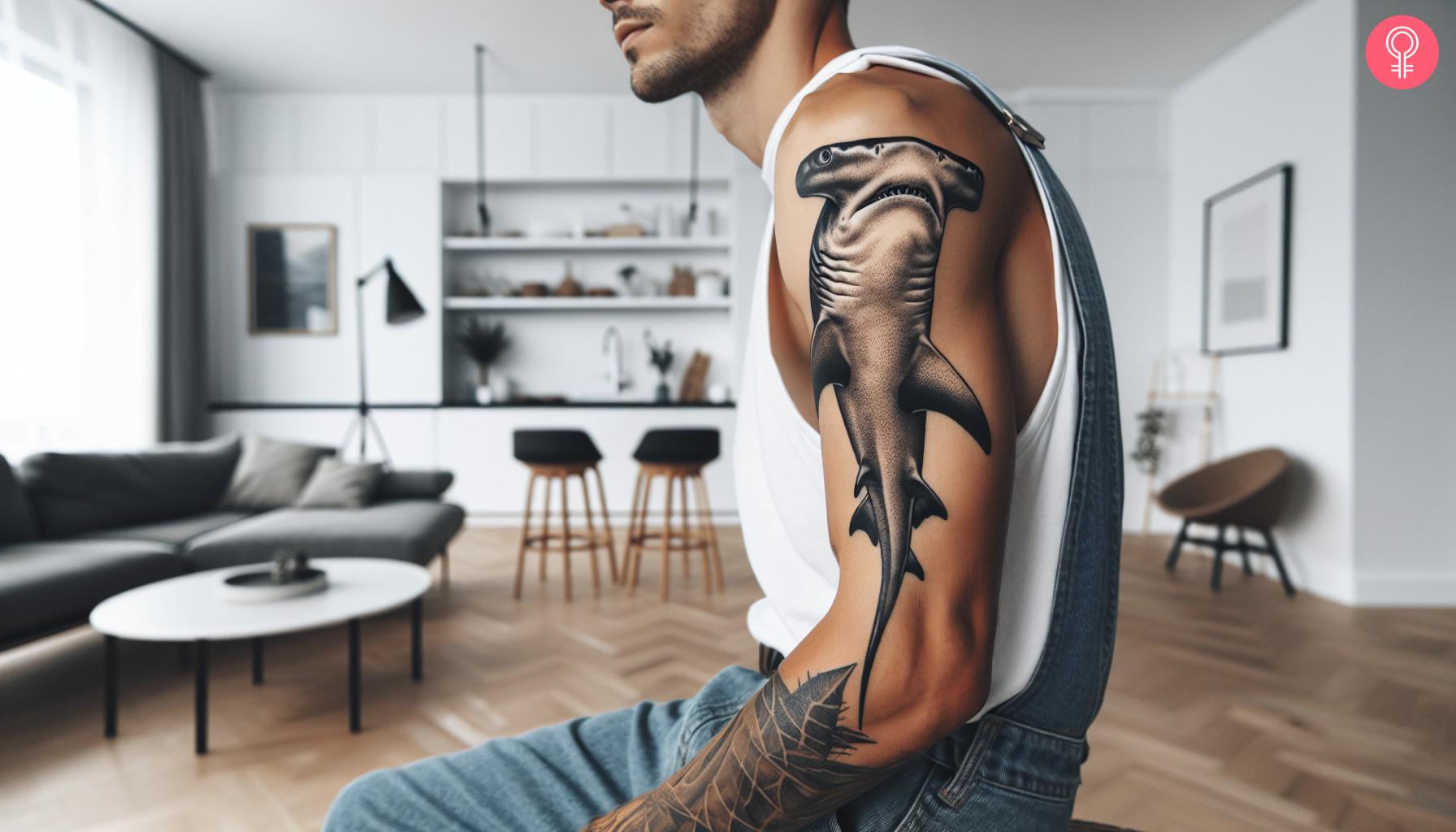 A realistic hammerhead shark tattoo on the upper arm