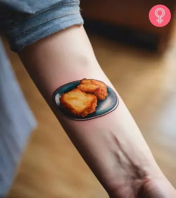 A realistic plate of chicken nugget tattoos on the forearm