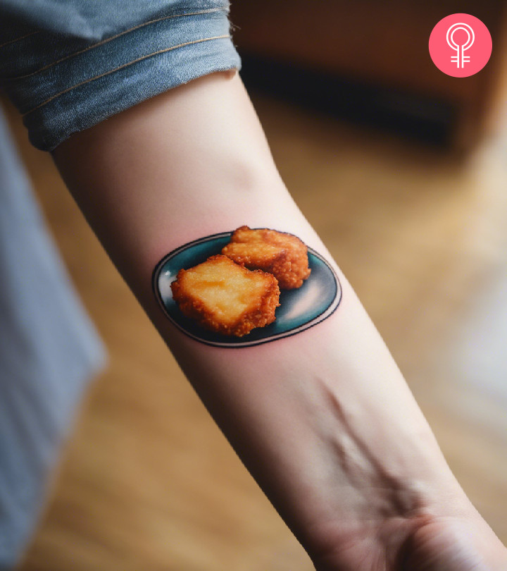 A realistic plate of chicken nugget tattoos on the forearm