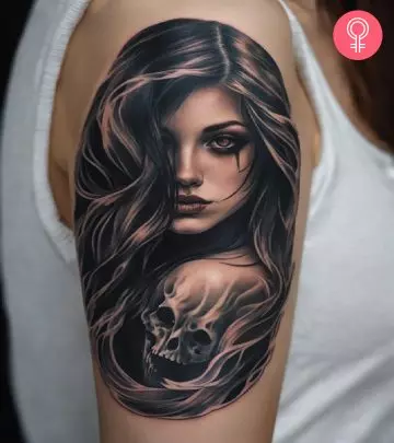 A woman with a minimalist ghost tattoo on her upper arm