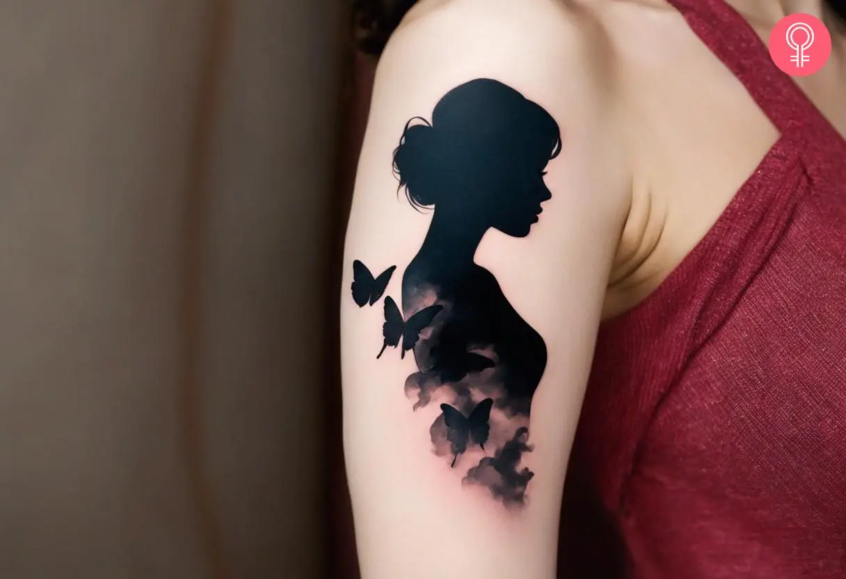 A shading smoke filler on a silhouette tattoo etched on a woman’s arm