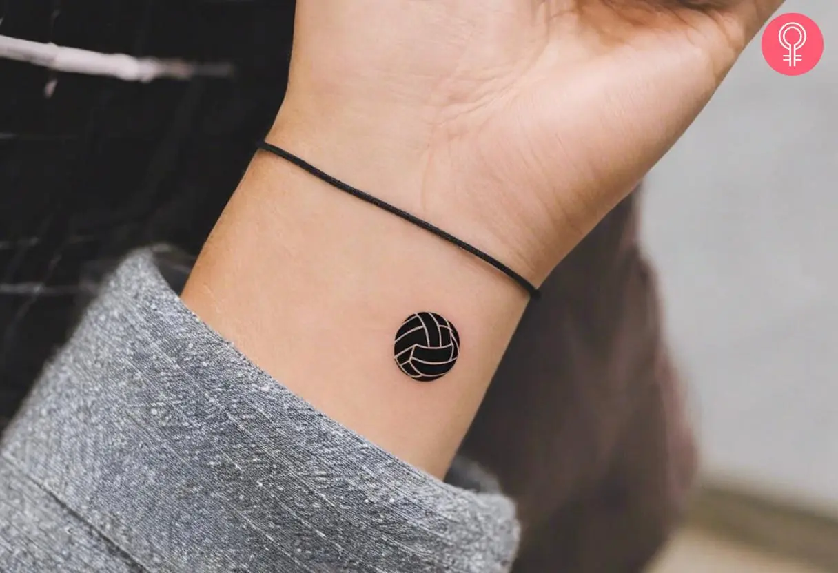 A simple volleyball tattoo on a woman’s wrist