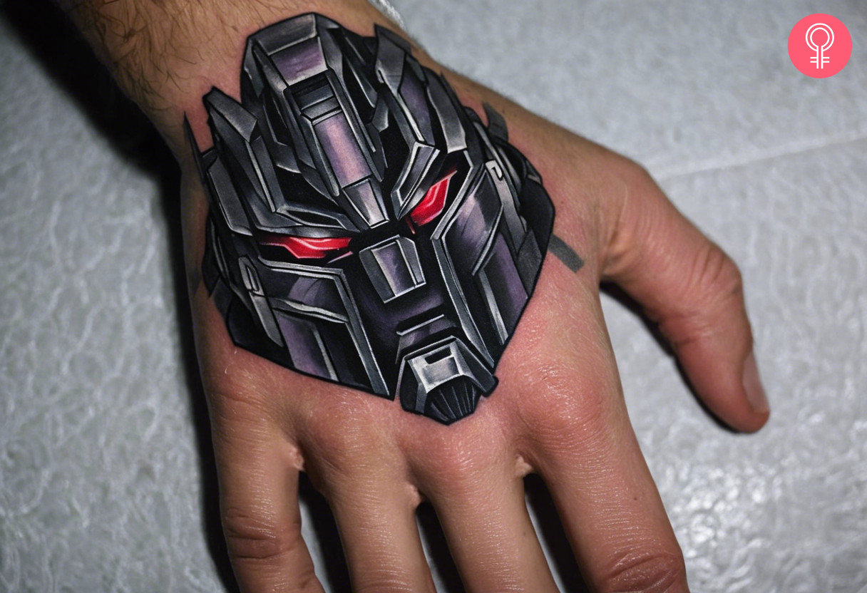 A small and realistic tattoo of megatron at the back of the hand