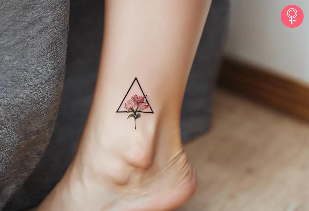 A small foot tattoo of a geometric floral design