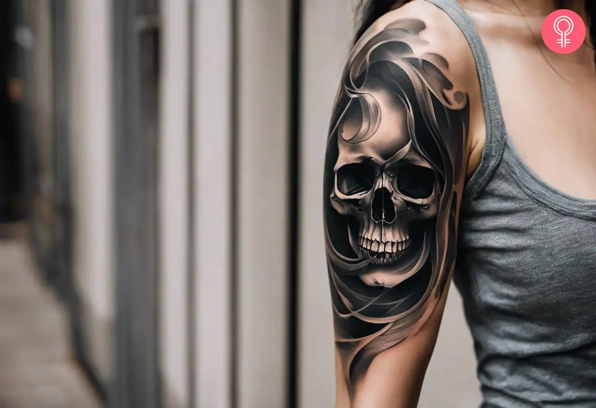 A smoke skull tattoo filler on a woman’s upper arm