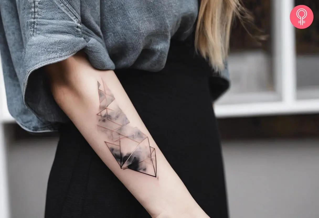 A smoke tattoo filler on a woman’s forearm