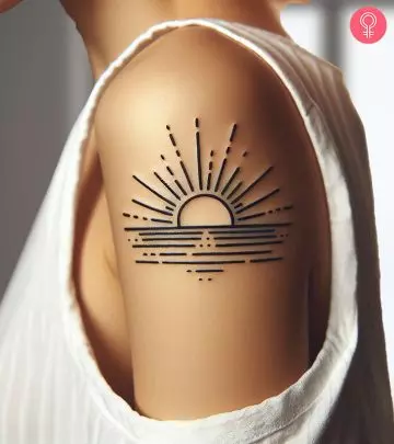 A tattoo of a serene sunrise on a woman’s arm