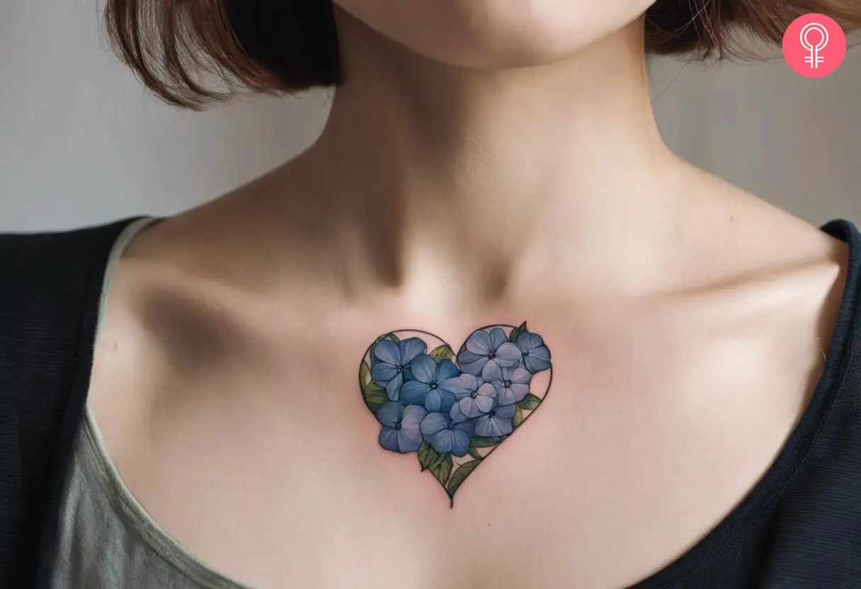 A tattoo of hydrangea flowers and a heart on the chest of a woman