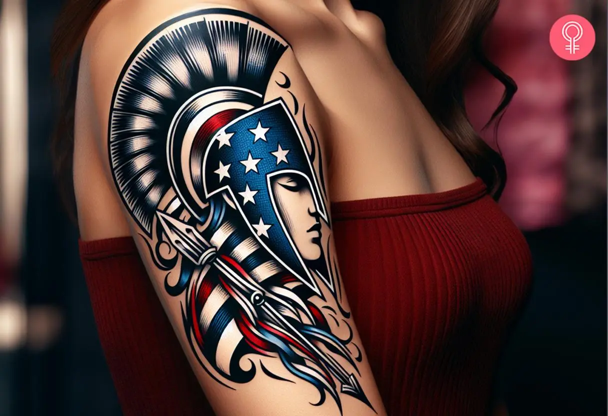 A tattoo on a woman’s upper arm featuring a spartan helmet in the colors of the American flag